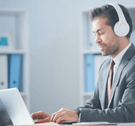 A linguist crafting accurate Bahasa language captions to help users understand multilingual videos using captioning services.