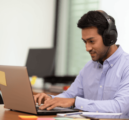 The professional uses captioned material created by a captioner in Grand Rapids to reach multilingual customers.