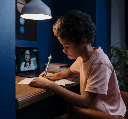 A student using captioning for online classes enhances accessibility and understanding of course content.