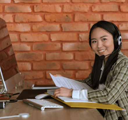 Smiling woman holding educational files, depicting French captioning for educational videos to enhancing accessibility.