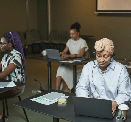 Woman working on a laptop for professional church sermon captioning services that ensure accurate and reliable captions.