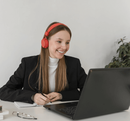 Smiling woman working on expert Canadian French captioning services designed to meet ADA compliance standards.