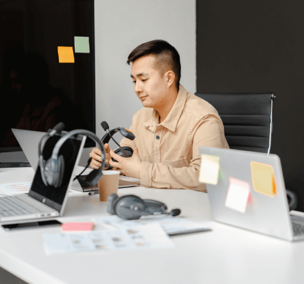 A man sitting at a table providing broadcast French captioning solutions tailored for media and television content.
