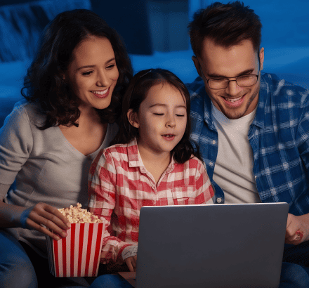 A family watching Netflix with captions in their preferred language, thanks to Vanan’s services.