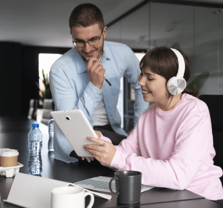 Office workers collaborating on broadcast projects, highlighting online captioning services that meet industry standards.