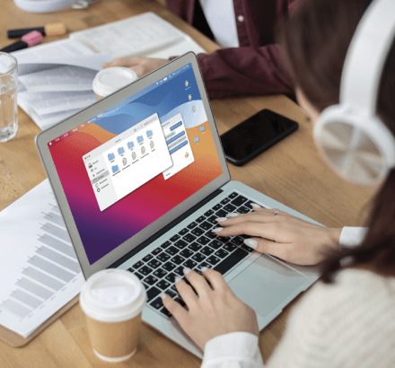 Captioner working on a laptop with diverse content, symbolizing accurate and reliable professional captioning services.