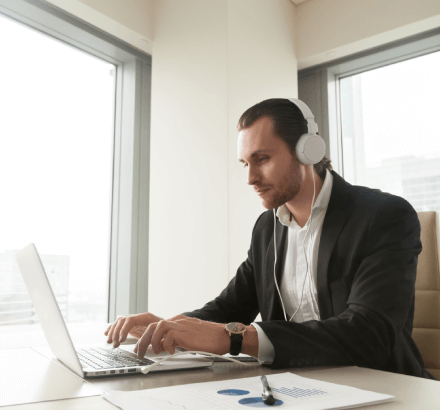 A businessman experiencing the benefits of Russian captioning services for expanding business communicates and engagement.