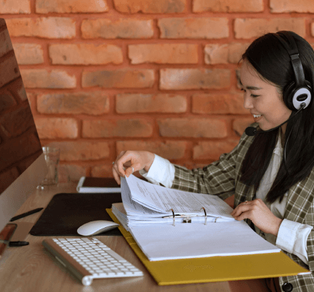 A woman reviewing documents, illustrating Russian captioning services preserve authenticity and clarity in documentaries.