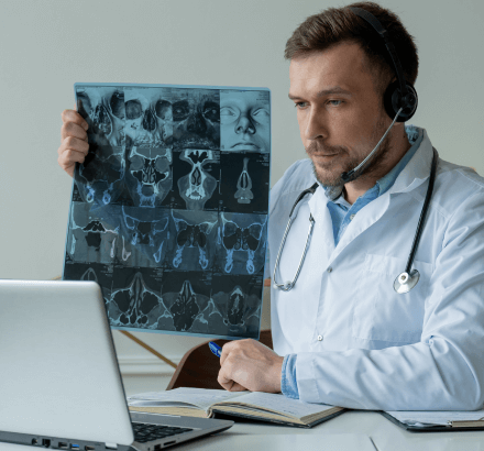 A doctor reviews radiology reports using precise ukrainian subtitling services for accurate communication.