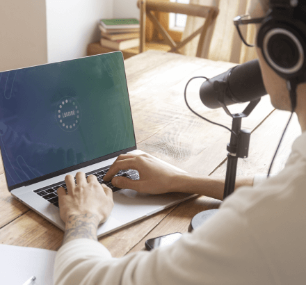 Side view of a man working on efficient and accurate voice recording transcription services for churches.